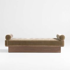 a bench made out of wood and upholstered with two curved backrests