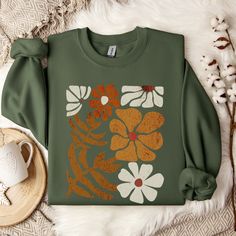 Boho Flower Fall Sweatshirt Graphic Sweatshirts Fall Sweatshirts Fall Sweater Fall Shirt Fall Shirts Boho Floral Shirt Wildflower Shirt Cottagecore Wildflower Sweatshirt This sweater is made from polyester and cotton. This combination helps designs come out looking fresh and beautiful.  The collar is ribbed knit, so it retains its shape even after washing.   Knit in one piece using tubular knit, it reduces fabric waste and makes the garment more attractive.  There are no itchy side seams on thes Casual Long Sleeve T-shirt With Plant Print, Cotton Floral Print Sweatshirt For Fall, Long Sleeve Cotton T-shirt With Floral Print, Casual Long Sleeve Tops With Plant Print, Green Tops With Plant Print For Fall, Green Long Sleeve T-shirt With Floral Print, Cotton Sweatshirt With Printed Relaxed Fit, Cotton Relaxed Fit Printed Sweatshirt, Fall Cotton Sweatshirt With Plant Print