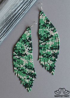 These camouflage beaded earrings are made of high-quality Czech beads and strong synthetic thread. They are elegant, fashionable, and highly versatile, suitable for everyday wear. Features: Sterling silver components Color: beige, green. This item is currently in stock. More beaded earrings http://etsy.me/2ycItdb Gerdan necklaces http://etsy.me/2mihf0J Beaded necklaces http://etsy.me/2Dkf1Fo Crochet necklaces http://etsy.me/2CAPdFc Back to shop https://www.etsy.com/shop/Namystynka Green Beaded Chain Earrings, Camo Earrings, Long Turquoise Earrings, Seed Beads Diy, Turquoise Bead Earrings, Blue Beaded Earrings, Beaded Chandelier Earrings, Bead Earring, Abstract Earrings