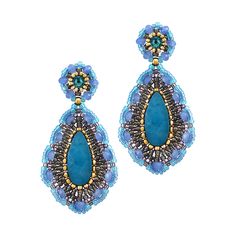 a pair of earrings with blue beads and gold trimmings on the ends, hanging from