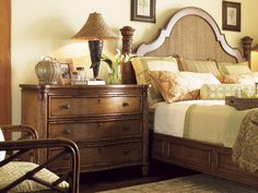 a bed sitting next to a dresser in a bedroom