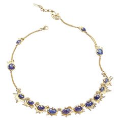 Sagrada Crescent Necklace Set in 20 karat Yellow Gold with 2.91-carat Diamonds and 27.20-carat Tanzanite.