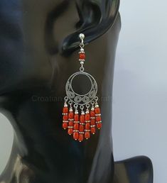 "♥ Meticulously handcrafted earrings made from precious Mediterranean coral. The coral is unique, all natural and hasn't been treated or dyed in any way. Earrings are based on a silver wire, around filigree centerpiece. Design of the filigree pattern, is inspired by traditional, Croatian filigree jewelry. Everything is handmade from solid sterling silver 925. ♥ Total dimensions: ~ 6.9 x 2 cm ( 2.71 x 0.79\" ) - - - - - - - - - - - - - - - - - - - - - - - - - - - Fast & Favorable 🛩️ DHL WORL Red Handmade Dangle Earrings, Red Handmade Dangle Danglers, Handmade Red Dangle Plug Earrings, Handmade Red Chandelier Earrings Gift, Traditional Earrings With Round Natural Stones, Traditional Earrings With Natural Stones, Traditional Red Handmade Chandelier Earrings, Handmade Red Coral Dangle Earrings, Artisan Red Earrings With Dangling Beads