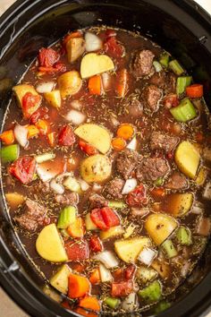 a crock pot filled with meat and vegetables