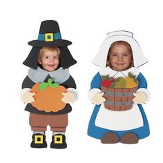 two children dressed up in halloween costumes holding pumpkins and apples, one wearing a witch costume