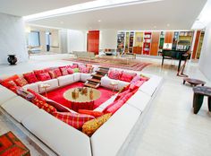 a living room filled with lots of furniture and bookshelves on top of each other