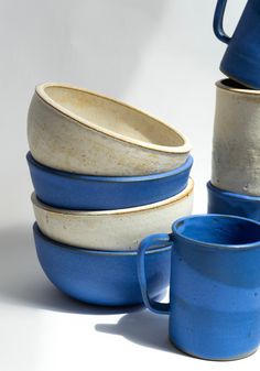 a stack of blue and white cups sitting next to each other