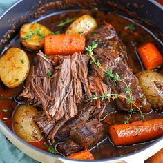 a pot roast with carrots, potatoes and beef