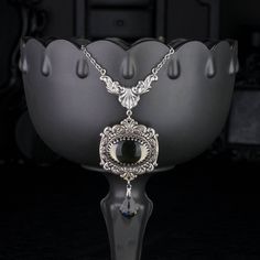 "💀 DESCRIPTION: This y necklace features a large vintage oval cabochon, in Black Diamond, that was hand set into a crown edge setting and layered onto ornate stampings with floral and flourish details. A faceted crystal pendant from Swarovski® dangles from the bottom. The entire ensemble dangles from beautiful Rococo style connector. The cable chain was finished with a lobster clasp and an extender. 💀 SIZE & MATERIALS: The vintage glass cabochon was made from glass in the 1970's and is from We Victorian Style Jewelry, Jewel Necklace, Gem Necklace, Glass Gems, Rococo Style, Necklace Statement, Gift For Girlfriend, Faceted Crystal, Grey Stone