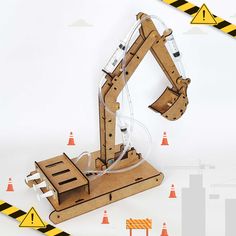 an image of a wooden robot that is in the middle of construction tape and orange cones