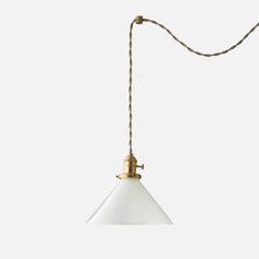 a white and gold light hanging from a cord