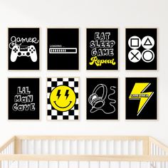 a baby's room with black and white art on the wall, including posters