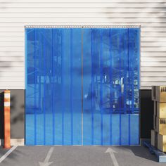 a large blue door is open in front of a building