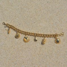 Created with an array of seashells, this is the ultimate beachcombers bracelet. Take a piece of the ocean with you wherever you go and be reminded of nature. We love chunky gold jewelry and this one is a favorite. Gold Filled Curb chain + Extender 6 Charms Cheap Dangle Charm Bracelet With Lobster Clasp, Chunky Gold Charm Bracelet, Chunky Gold Jewelry, Gold Charm Bracelet, Beach Combing, Chain Extenders, Curb Chain, Gold Charm, Hair Jewelry