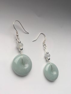 Special sage green jade dangle & drop earrings handmade with quality Chinese jade and 925 Sterling silver hooks and parts. The fine light smoky green jade and white small jade ball are icy and natural. Minimalist and delicate design inspired by traditional Chinese decorations. Some highlights of this pair of cute Chinese jade earrings are: ＊High-quality materials Hand made with grade-A natural green & white jade and 925 sterling silver. ＊Simple and graceful Unique sage green jade donut a Nickel-free Round Jade Jewelry, Nickel-free Round Jade Earrings, Spiritual Jade Dangle Earrings, Round Jade Jewelry With Matching Earrings, Aventurine Round Jewelry For May Birthstone, Aventurine Jewelry For May Birthstone In Round Shape, Aventurine Jewelry For May Birthstone, Silver Aventurine Dangle Jewelry, Nickel-free Jade Jewelry For Healing