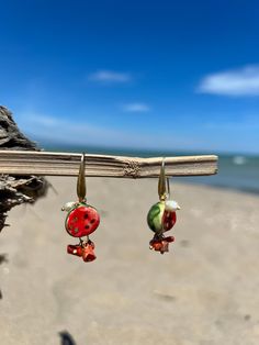 Sicilian earrings with hand-painted ceramic with fine gold touches Mounted in brass with Mediterranean coral and river pearls Summer Polymer Clay Earrings For Gifts, Summer Gift Polymer Clay Earrings, Summer Gift Earrings In Polymer Clay, Artisan Enamel Jewelry With Ear Wire, Artisan Handmade Pearl Earrings Gift, Red Hand-painted Dangle Jewelry, Bohemian Polymer Clay Jewelry For Beach, Red Hand Painted Dangle Jewelry, Hand Painted Red Dangle Jewelry