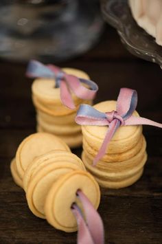 small macaroons with ribbons tied around them on a table