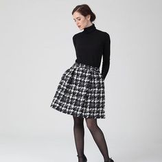 a woman in black and white plaid skirt