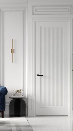 a blue chair sitting in front of a white wall with a cross on the door