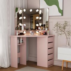 a pink vanity table with lights on it