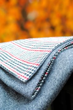 a close up view of the back pocket of a pair of jeans with a plaid pattern