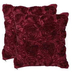 two pillows with red roses on them, one is made out of velvet and the other has