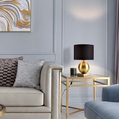 a living room filled with furniture and a painting on the wall next to a table