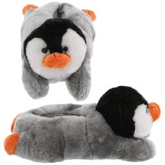 a stuffed penguin laying on top of a pillow