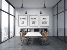 an empty conference room with two posters on the wall and four chairs in front of it