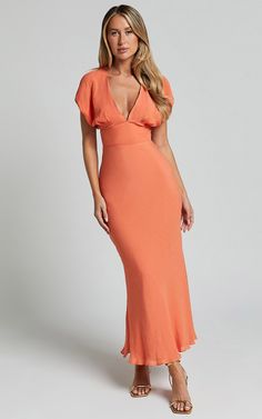 a woman in an orange dress