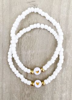 White Heart Friendship Bracelets 🤍🤍 Simple and cute! Perfect to add to any stack. Match with your best friend or group of friends ✨✨ CARING TIPS FOR YOUR JEWELRY ⭐️Treat and store with care. ⭐️ For longevity, avoid exposing your jewelry to water. ⭐️ Avoid having direct contact with lotions, perfumes, sanitizers as these chemicals may cause discoloration of your jewelry. Cheap White Friendship Bracelets With 8mm Beads, Cheap White Friendship Bracelets, Handmade White Friendship Bracelets For Everyday, Everyday Handmade White Friendship Bracelets, White Stretch Bracelet With Round Beads For Gift, White Dainty Friendship Bracelets With Round Beads, Dainty White Charm Bracelet For Everyday, Dainty White Friendship Bracelets With Round Beads, Dainty White Stretch Bracelet For Everyday