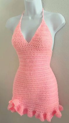 a pink crocheted halter top on a mannequin