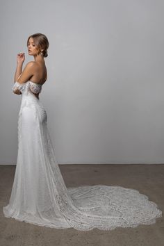 a woman in a wedding dress is posing for the camera with her hand on her face