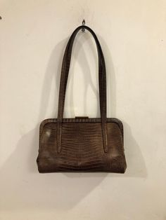 "Sondra Roberts - A dark chocolate brown and slightly copper toned \"faux\" snakeskin handbag with a covered metal frame and gold toned clasp.   An elegant, timeless classic, beautifully crafted - perfect for any occasion, any season. * dimensions: 9\" x 6\" x 3 1/2\" tapered to 1 1/2\" * a pair of 1/2\" x 21\" straps of the same material * lined with a soft cocoa smooth leatherette  * open wall pockets with the Sondra Roberts logo   * nice details * excellent condition Please note: ALL my bags Classic Crocodile Pattern Shoulder Bag For Formal Occasions, Classic Formal Shoulder Bag With Crocodile Pattern, Formal Brown Rectangular Bag, Brown Double Handle Satchel For Formal Use, Vintage Brown Elegant Shoulder Bag, Elegant Vintage Brown Shoulder Bag For Daily Use, Formal Brown Shoulder Bag With Detachable Handle, Formal Brown Satchel Shoulder Bag, Formal Brown Textured Leather Bag