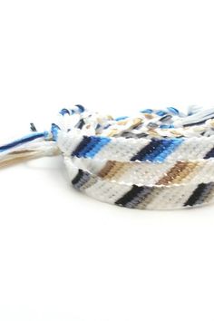 three braided bracelets with blue, white and brown stripes on each one side