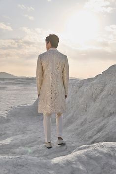 This set features all over mirror work on a raw silk base. It is paired with an off-white silk kurta and an off-white straight pants. Complementing stole is also available.From Seema Gujral's Elements collection. DELIVERY TIMEPlease allow 6-8 weeks for your outfit to arrive. FABRIC DETAILSSherwani - Raw Silk Kurta - Silk Trouser - Stretchable TR Professional cleaning only. White Sherwani, Raw Silk Kurta, Raw Silk Embroidery, Seema Gujral, Embroidery Mirror, Sherwani For Men, Silk Kurta, White Mirror, Vogue India