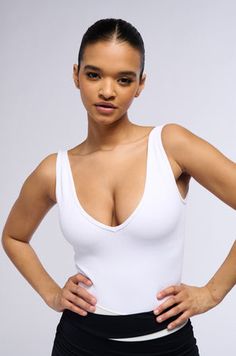 DEEP V RIBBED TANK BODYSUIT IN WHITE Solid Ribbed V-neck Bodysuit, Solid Color Ribbed V-neck Bodysuit, Fitted Ribbed Tank Bodysuit, White Seamless V-neck Bodysuit, Tank Bodysuit, Ribbed Tank, Cinched Waist, Deep V, White