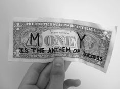 someone holding up a money bill with the words money is the antem of success