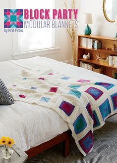 a bed with a quilt on top of it in a bedroom next to a book shelf