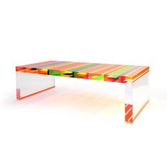 a multicolored coffee table with an acrylic design on the top and bottom