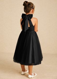 Dora features a charming A-line silhouette in matte satin and tulle, with a stylish halter neckline and playful bows. Sleeveless and easy to wear with a zipper back, it’s perfect for adding a touch of elegance to any special occasion. Sleeveless Tulle Tutu Dress With Bow, Black Sleeveless Halter Wedding Dress, Black Sleeveless Halter Dress For Wedding, Party Dress With Satin Bow And Tulle Material, Party Dresses With Bow Straps And Tulle Material, Elegant Bridesmaid Tutu Dress With Bow, Elegant Sleeveless Tutu Dress With Bow, Black Dress With Satin Bow For Party, Black Dress With Detachable Bow For Party