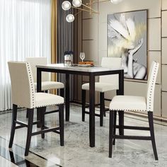 a dining room table with four chairs and a painting on the wall in the background