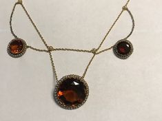 "A late victorian or Edwardian(circa 1890-1915), 18k(750 stamped on spring ring), yellow gold large fancy bezel set Madera Citrines and natural pearl necklace.  Condition-no problems, bright yellow gold all seed pearls in gallery framing citrines are present and lustrous.  Delicate floral , pearl stations from which the chain swags. The center citrine is 21mm(central pendant is 26mm, two smaller citrines are 12mm.  Lenght  16\", wt. 20.4 grams.  Best deep golden/hint or orange color.  Finest qua Evening Yellow Gold Cabochon Jewelry, Antique Yellow Gold Necklace With Cabochon, Antique Round Necklace With Rose Cut Diamonds, Victorian Yellow Gold Cabochon Jewelry, Fine Jewelry Wedding Necklace With Cabochon, Wedding Fine Jewelry Necklace With Cabochon, Victorian Jewelry With Rose Cut Diamonds For Formal Occasions, Victorian Style Rose Cut Diamonds Jewelry For Formal Occasions, Evening Yellow Gold Jewelry With Rose Cut Diamonds