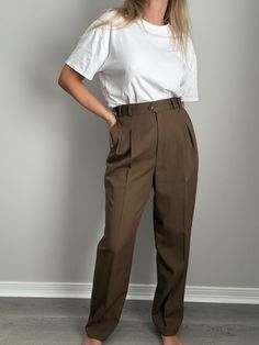 Vintage | Deadstock Liz Claiborne trousers from the 80s. Color is somewhere around an olive drab / brown. Tag still attached. Fabric: 100% wool Vintage Size: 12 Measurements taken flat: waist 14.5" + hips 23" + rise 13" + inseam 30.5" Model specs: medium frame + height 5'7" + bust 36" + waist 29" + hips 40" All vintage items are preloved and due to their delicate nature, subtle flaws and natural signs of wear are to be expected. Please be gentle & treat with care. Reach out with any questions, all sales are final. Vintage Workwear Pants For Fall, Classic High Waist Brown Pants, Vintage Khaki Bottoms For Fall, Vintage Fall Workwear Pants, Retro Brown Bottoms For Workwear, Classic Khaki Bottoms For Fall, Vintage Business Casual Bottoms For Fall, Vintage Bottoms For Business Casual Fall Season, Vintage Bottoms For Business Casual In Fall