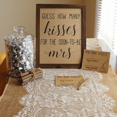 there is a sign that says guess how many kisses for the son - to - be mrs