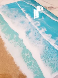 an image of blue and white water on the beach with waves coming in to shore