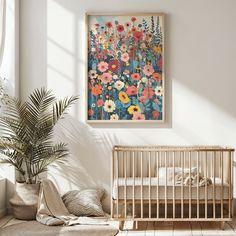 a baby's room with a crib, plant and painting on the wall