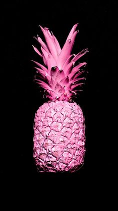 a pink pineapple sitting on top of a black table