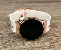 High Quality White Genuine Leather Strap Band Compatible with : Galaxy Watch (42mm) | Galaxy Watch Active | Watch Active2 (40mm) | Watch Active2 (44mm) | Adjustable Size Bracelet Perfectly Tailored to Fit Your Wrist. Designed And Handmade by Simeon D Jewelry. The Bracelet is Super Easy to Install on Your Watch. Comes with 4pcs 20mm Quick Release Pins. Please Measure Your Wrist Before Submitting Your Order! Samsung Watch Is NOT Included Create Your Own Unique Style! Be Different! Be Unique! Make White Leather Strap Watch Bands For Gift, White Leather Strap Watch Band As Gift, Rose Gold Watch Bands As Gift, White Watches With Leather Strap As Gift, White Watches With Leather Strap For Gifts, Gift White Watches With Leather Strap, Rose Gold Bracelet Strap Watch Accessories, Rose Gold Round Bracelet Strap Watch Accessories, Rose Gold Round Watch With Bracelet Strap