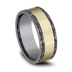 a wedding band that is made from yellow gold and black ceramic with an antelope inlay